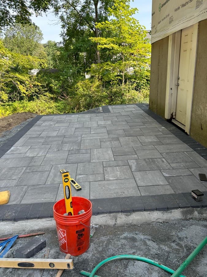 Airton, owner of Levi Construction, on a hardscape job site